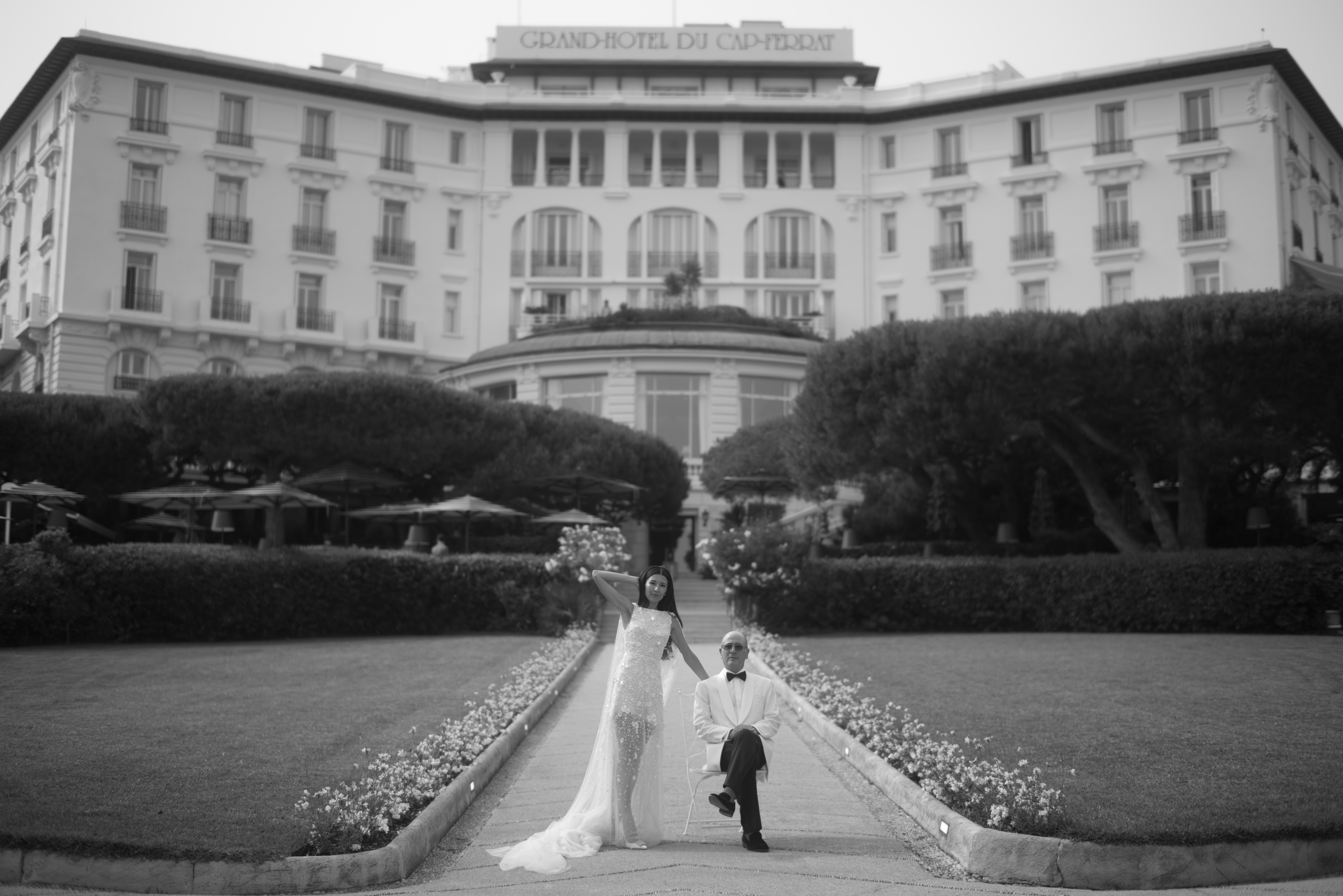 Taylor and Rob exchanging vows on a sunlit terrace at Four Seasons Cap Ferrat, surrounded by lush floral arrangements and overlooking the Mediterranean Sea.